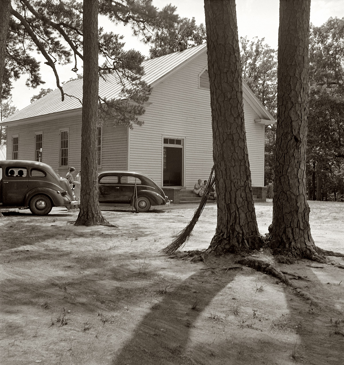 July 1939. "Churchyard on annual cleaning up day, Wheeley's Church, Person County, N.C." View full size. Medium-format nitrate negative by Dorothea Lange. Note the homemade twig brooms propped against the pine. From an earlier post, a group shot of the ladies. Is the church, in Gordonton, still there?