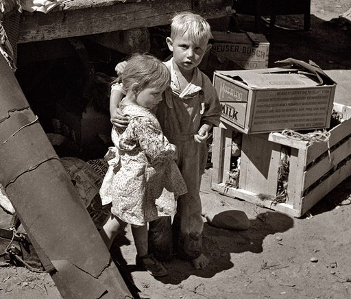 August 1939. Migratory children living in "Ramblers Park." They have lived on the road for three years. Nine children in the family. Yakima Valley, Washington. View full size. Photograph by Dorothea Lange.