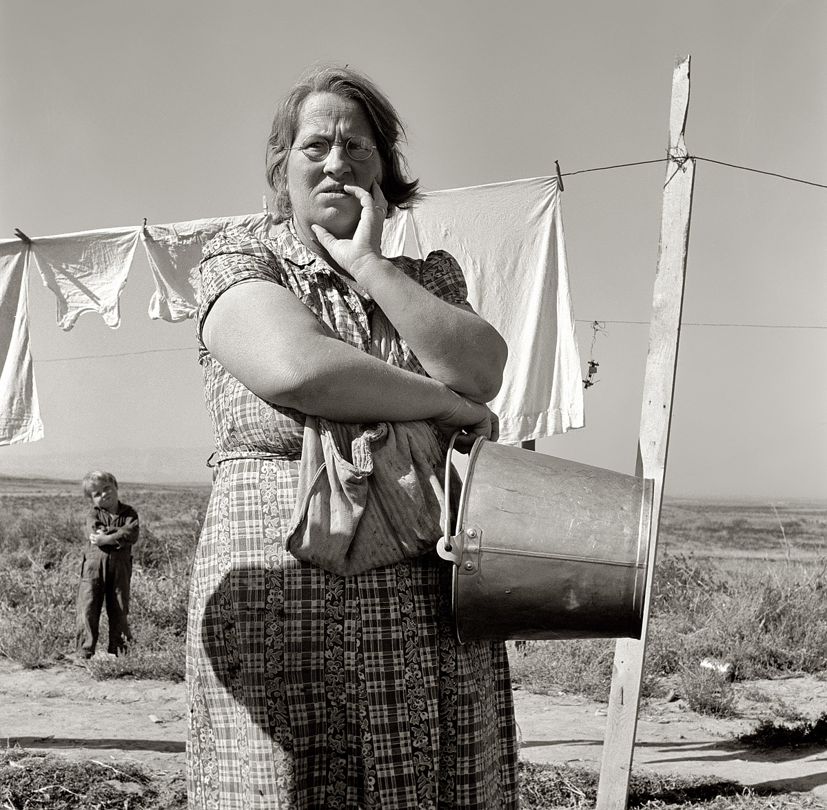 September 1939. "Mrs. Soper, FSA client, tells how it was when the family first came." Willow Creek area, Malheur County, Oregon.  Medium-format negative by Dorothea Lange for the Farm Security Administration. View full size.