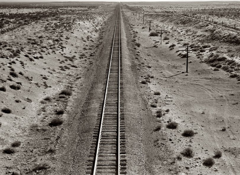 October 1939. Western Pacific tracks through the unclaimed desert of northern Oregon, 10 miles from the railroad station at Irrigon. View full size. 4x5 nitrate negative by Dorothea Lange for the Farm Security Administration.