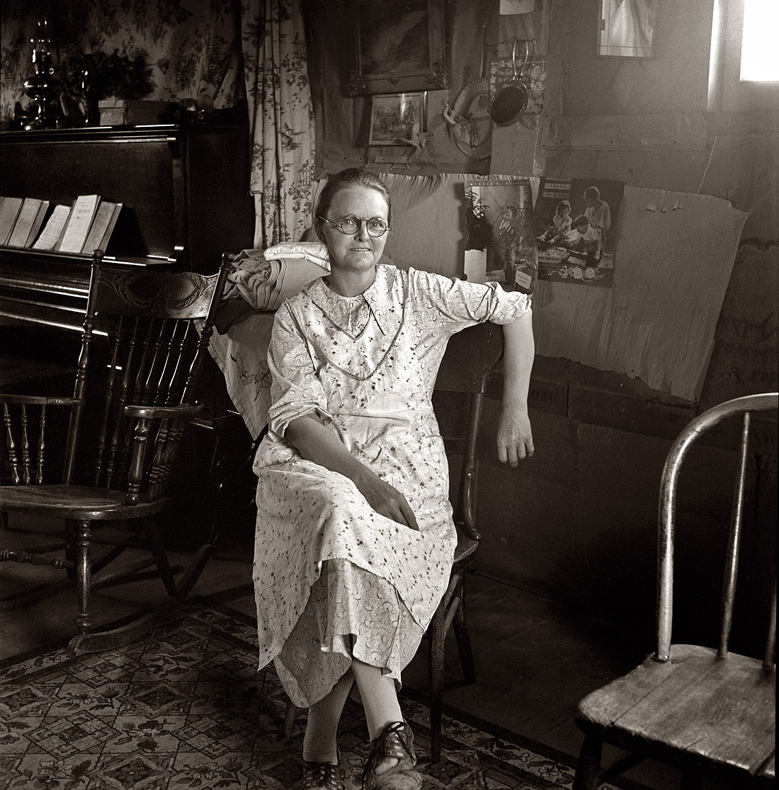 October 1939. "Mrs. Hull, in one-room basement dugout home. Dead Ox Flat, Malheur County, Oregon." View full size. Photograph by Dorothea Lange.