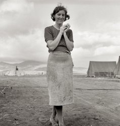 October 1939. "Young migrant mother has just finished washing. Merrill Farm Security Administration camp, Klamath County, Oregon." View full size. Medium format nitrate negative by Dorothea Lange for the FSA.