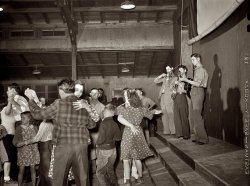 February 1942. Weslaco, Texas. Saturday night dance at the Farm Security Administration camp with music by the Drake family. View full size. Medium-format safety negative by Arthur Rothstein for the FSA.