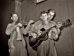 Weslaco, Texas. The "musical Drake family," performing at a  barn dance in the Farm Security Administration's Mercer G. Evans camp, February 1942. Medium-format safety negative by Arthur Rothstein for the Farm Security Administration. Update: The fiddler is Nathan Drake, the younger boy is Jasper "Sleepy" Drake, and behind him is brother Weldon Drake. View full size.