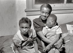 April 1941. "Mother and two children. Family is on relief. Chicago, Ill." Acetate negative by Russell Lee for the Resettlement Administration. View full size.
