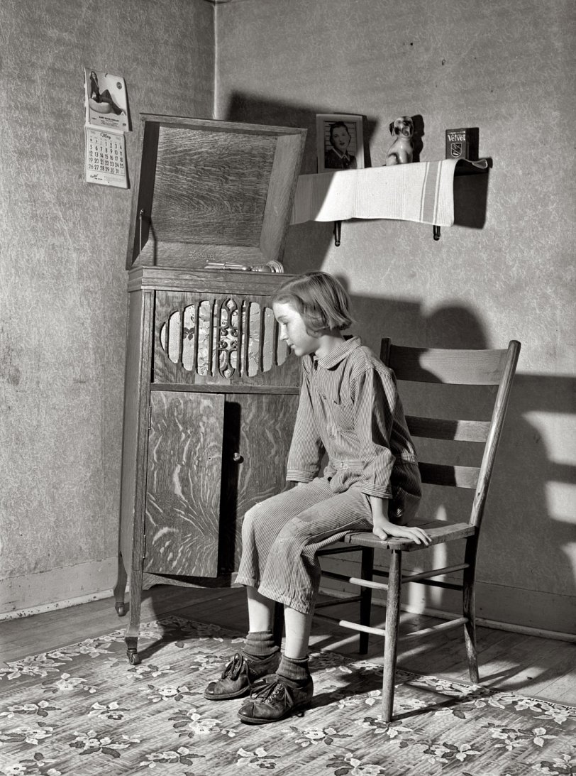 May 1940. Crawford County, Illinois. "Daughter of Farm Security Administration rehabilitation borrower listening to phonograph." View full size. Medium format safety negative by John Vachon for the Farm Security Administration.
