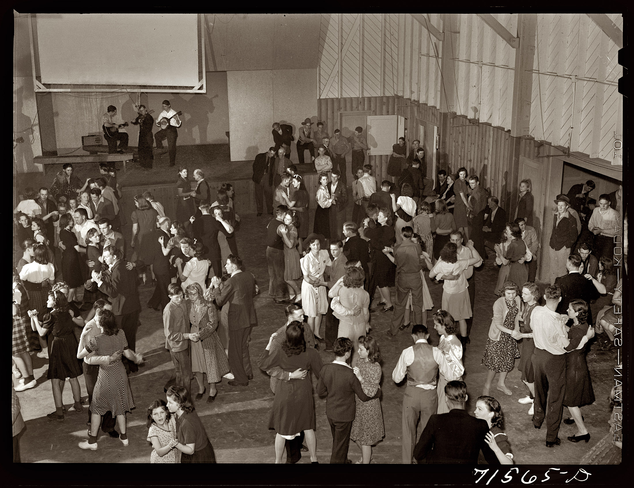 January 1942. Community house Saturday night dance in the Farm Security Administration settlement of Woodville, California. View full size. Medium format safety transparency by Russell Lee for the Farm Security Administration.