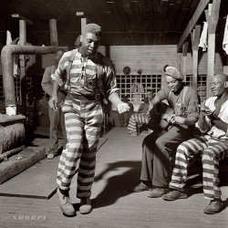 May 1941. Music-making in the convict camp at Greene County, Georgia. Medium-format nitrate negative by Jack Delano. View full size. The guitarist, one Shorpy reader points out, is bluesman Buddy Moss.