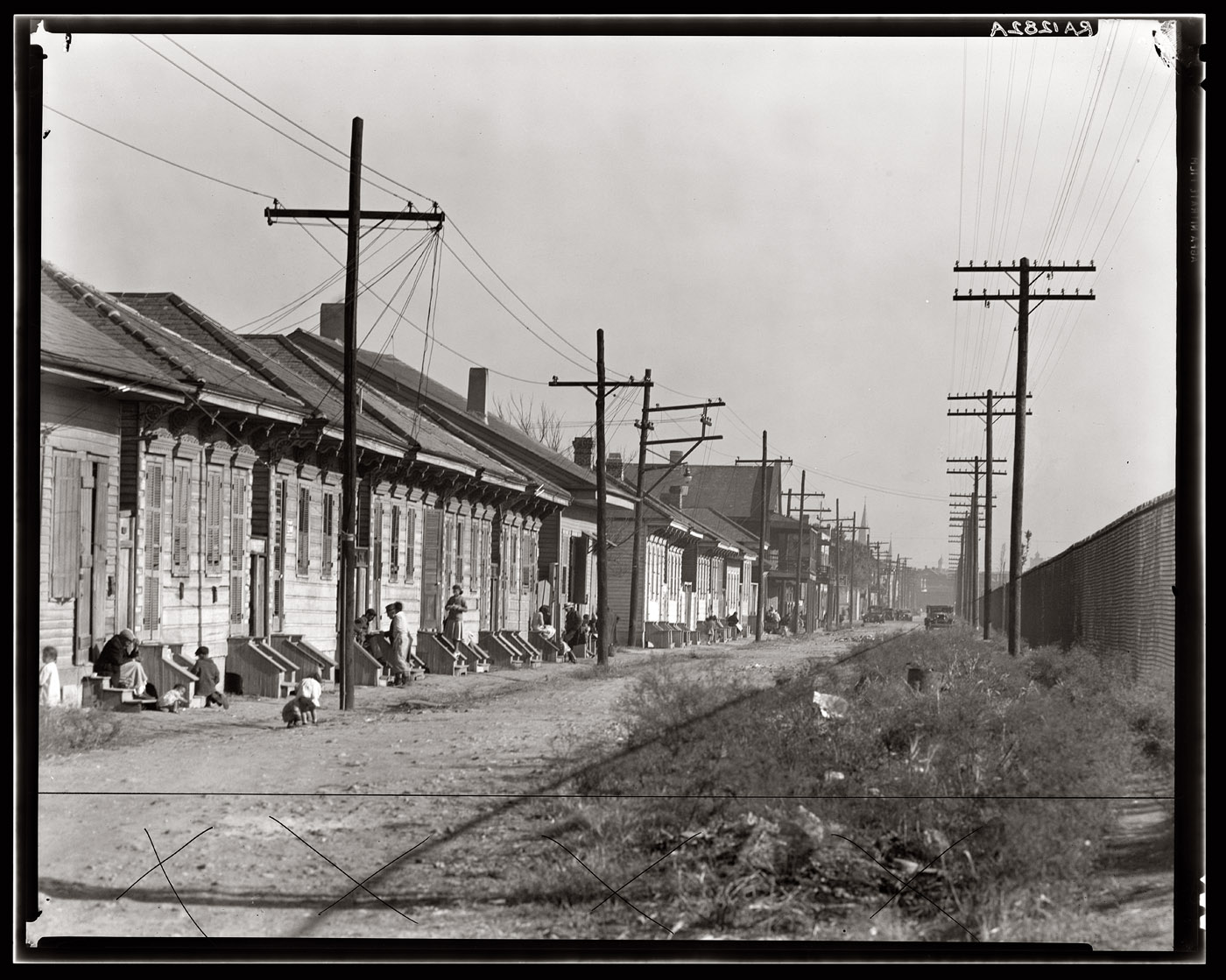 "New Orleans Negro street," December 1935. View full size. Photograph by Walker Evans. X's at bottom are crop marks.