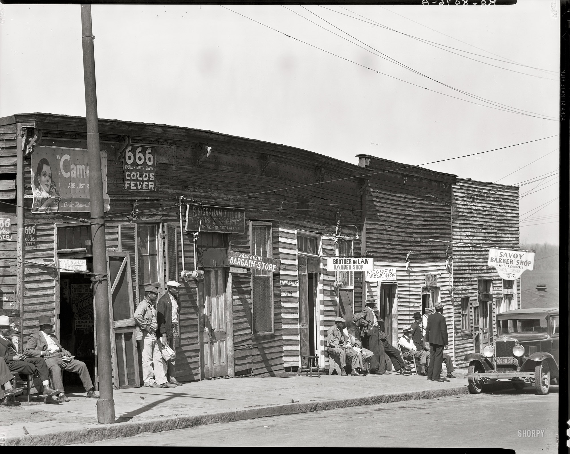 March 1936. Vicksburg, Mississippi. "Vicksburg Negroes and shop front." 8x10 inch nitrate negative by Walker Evans for the Resettlement Administration. View full size. 