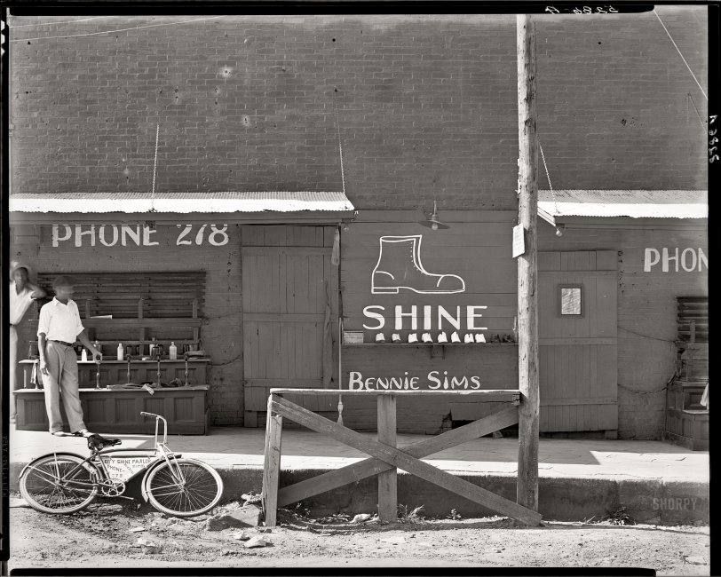"Shoeshine stand, Southeastern U.S., 1936. (Title and date from Walker Evans, 1973. No caption for this image in FSA/OWI shelflist.)" Who will be the first Shorpyite to clear up a longstanding curatorial mystery and figure out where this is? Large-format safety negative by Walker Evans for the FSA. View full size.
