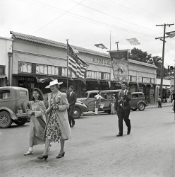 May 1942. "In the parade of the Festival of the Holy Ghost, a Portuguese-American celebration. Novato, California." Medium format negative by Russell Lee for the Office of War Information. View full size.
Very few spectatorsfor the Holy Ghost parade.  Brings to mind Mellencamp's "I was born in a small town, etc."
H. Pini &amp; Co.  destroyedby fire in 1944.
[The fire was on April 19, 1945 according to the Novato Historical Guild. -tterrace]
A man and his truckThe history of McClelland's Dairy.
Still in business in NovatoPini &amp; Co. rebuilt and opened in a new location down the street in 1946, then moved a few years ago to a shopping center where it's now Pini Ace Hardware. Their 1946 location remains unoccupied, unfortunately.  I live a few blocks away so I know the neighborhood well.
(Russell Lee, Stores & Markets)