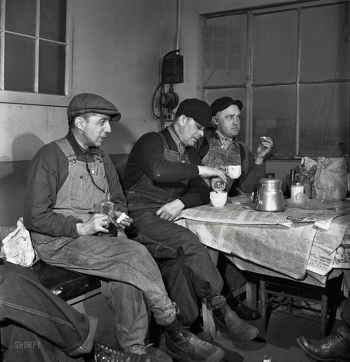 February 1943. "Daniel Senise (center) at lunch in the work shanty at an Indiana Harbor Belt Line rail yard. With him are switchmen John McCarthy (left) and E.H. Albrecht." Medium-format nitrate negative by Jack Delano. View full size.