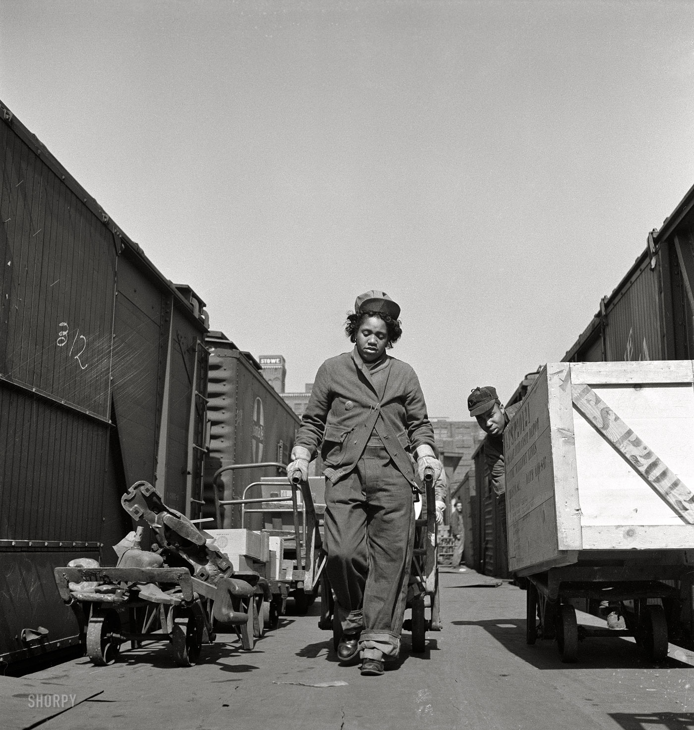 March 1943. Kansas City, Missouri. "Mildred Williams, one of several women freight handlers employed at the Atchison, Topeka, and Santa Fe depot." Medium-format negative by Jack Delano, Office of War Information. View full size.