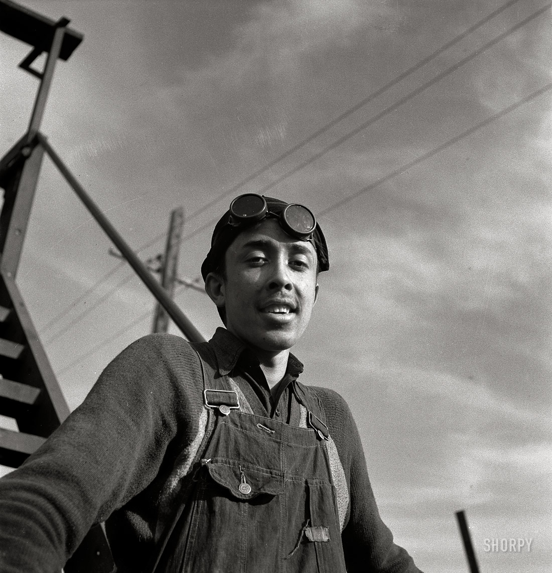 March 1943. "Topeka, Kansas. Eladio Tostado, steel car repairer's helper and rivet heater, at car shops of the Atchison, Topeka and Santa Fe." Medium-format negative by Jack Delano for the Office of War Information. View full size.