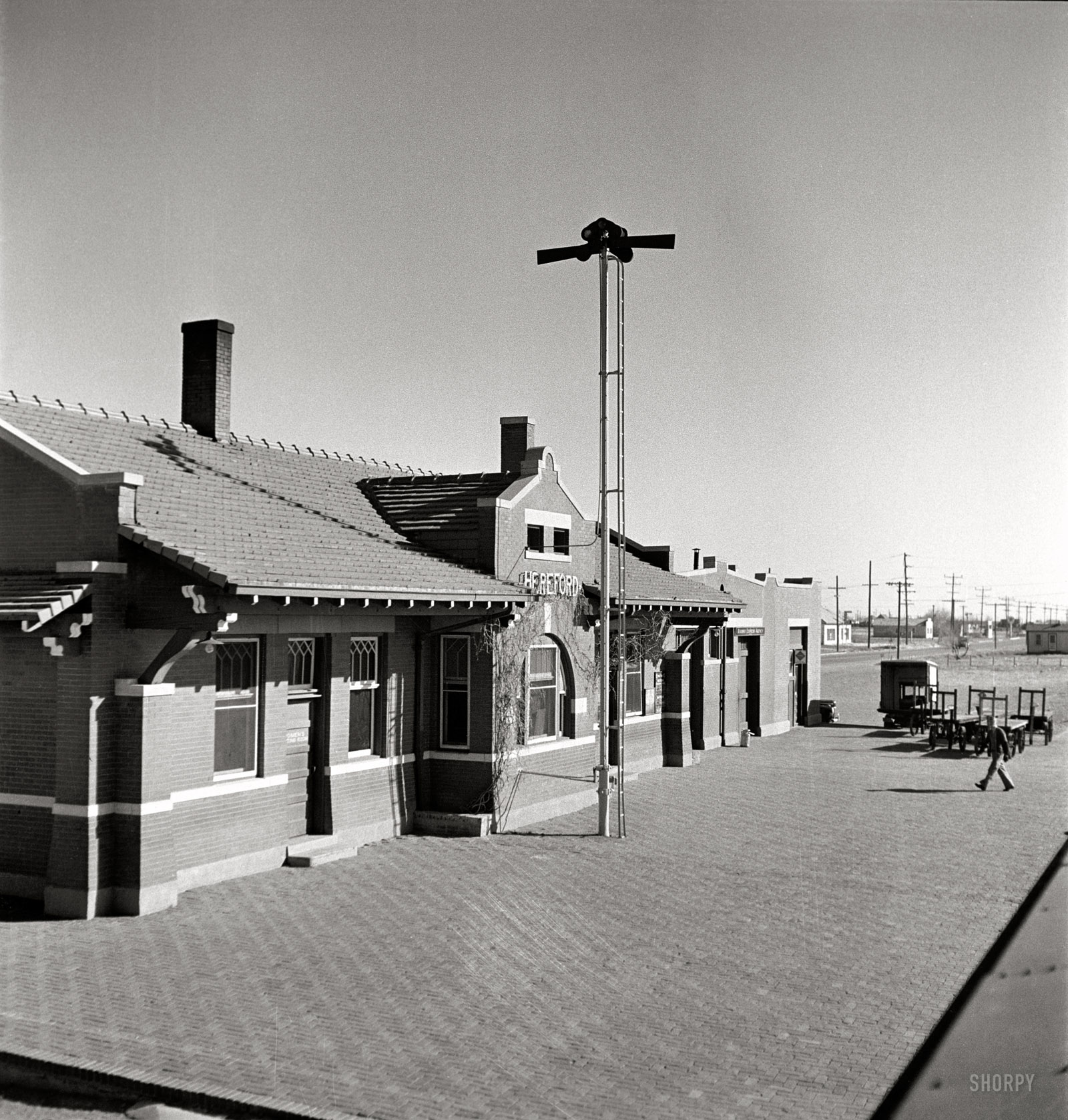 March 1943. "Hereford, Texas. Passing the depot on the Atchison, Topeka, and Santa Fe Railroad between Amarillo, Texas, and Clovis, New Mexico." Nitrate negative by Jack Delano for the Office of War Information. View full size.