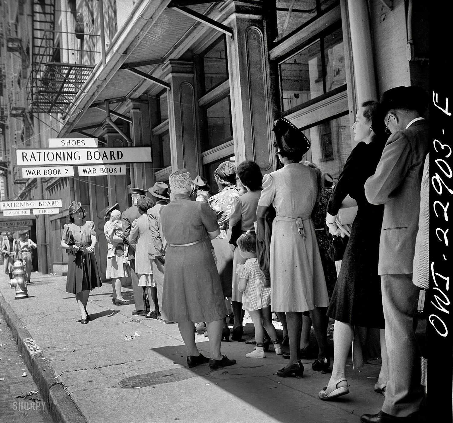 March 1943. "New Orleans, Louisiana. Line at rationing board." Medium format negative by John Vachon for the Office of War Information. View full size.