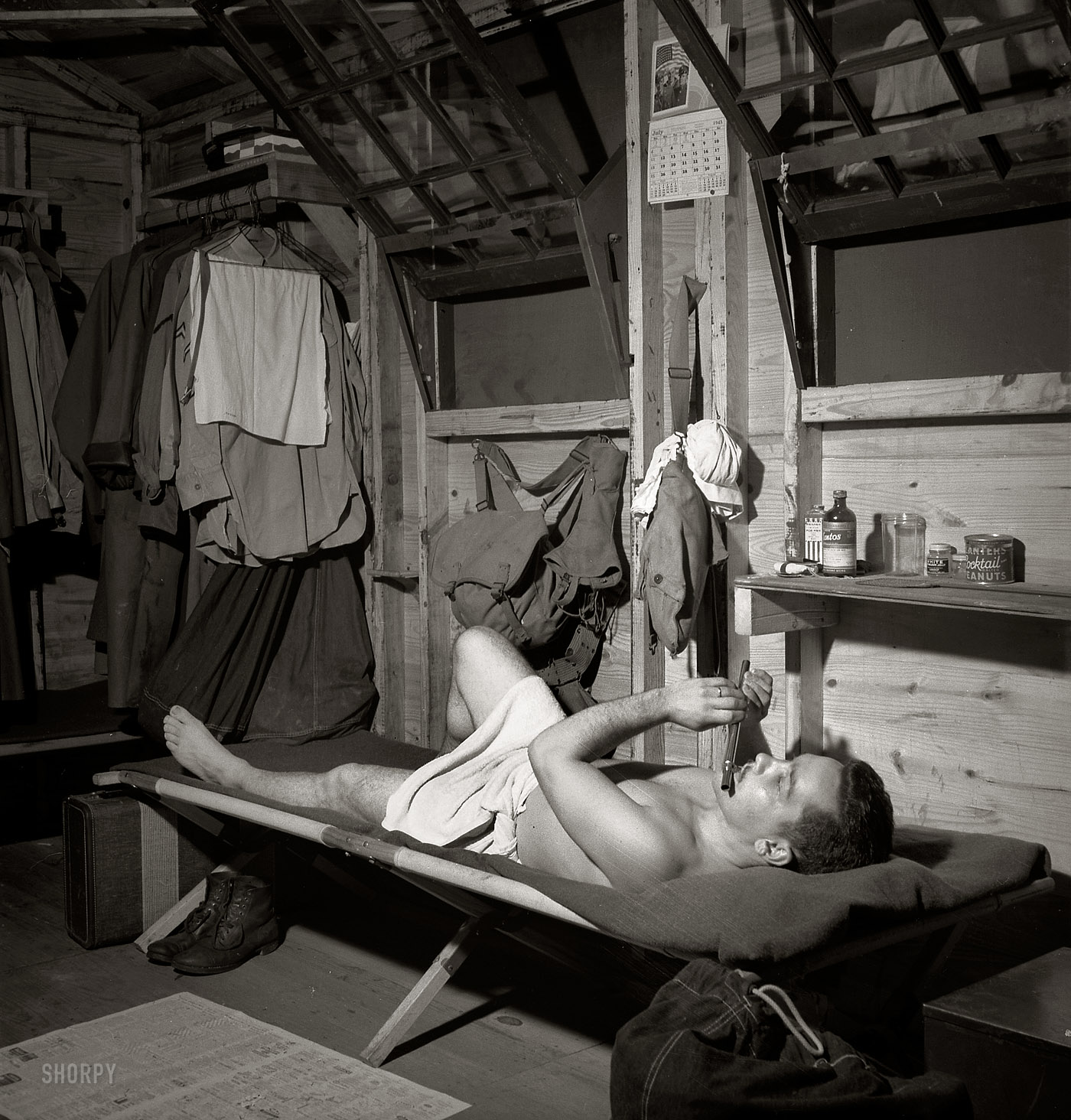 July 1943. "Greenville, South Carolina. Air Service Command. A scene in one of the barracks. Enlisted man playing the flute after he has taken a shower." Photograph by Jack Delano for the Office of War Information. View full size.