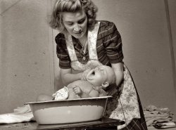 December 1943. "Lynn Massman, wife of a second class petty officer studying in Washington, D.C., giving eight weeks old Joey his daily bath." The Massman family was the subject of dozens of photos shot by Esther Bubley for the Office of War Information. View full size. Epilogue: Joe, a lawyer, died in March 2000 in Montana. His dad, Hugh, died two years later. Lynn, a mother of eight, passed away in 1983 after a very active life. Click here for remarks by her son Bascomb.