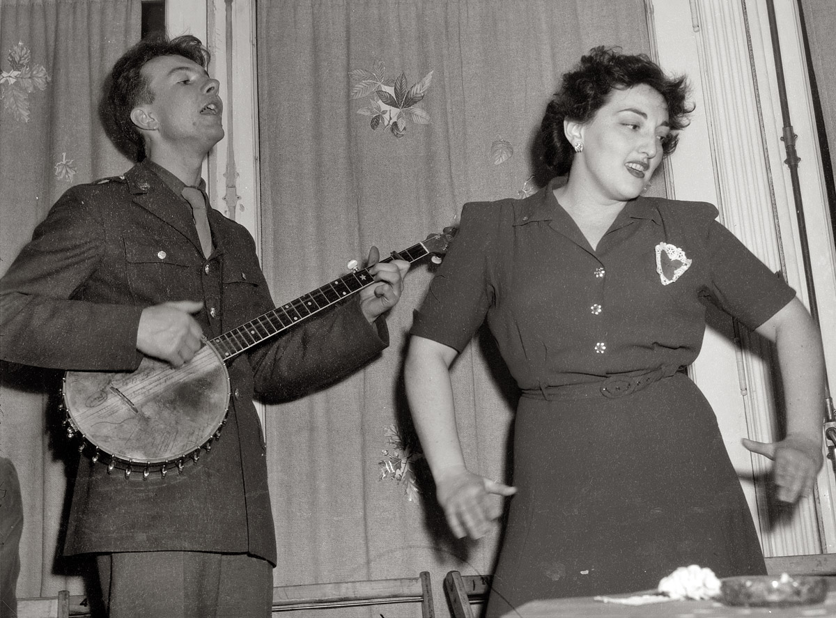 February 1944. Pete Seeger singing at a Valentine's Day party to mark the opening of the United Federal Labor Canteen in Washington. View full size. Medium-format safety negative by Joseph Horne for the Office of War Information.