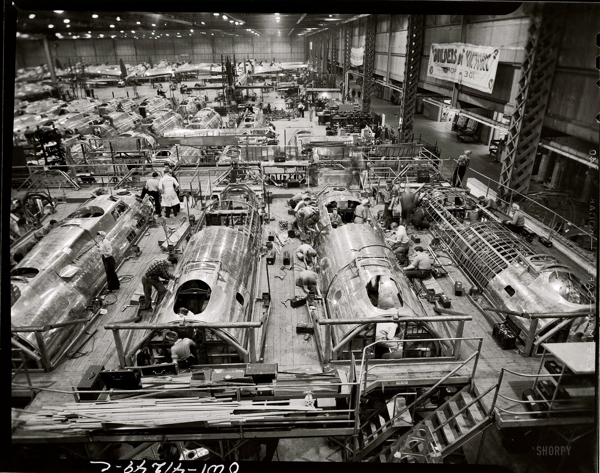 "Bomber factory. No caption for this image." 1943 or 1944. So, what are they and where is Shop 301? Office of War Information safety negative. View full size.