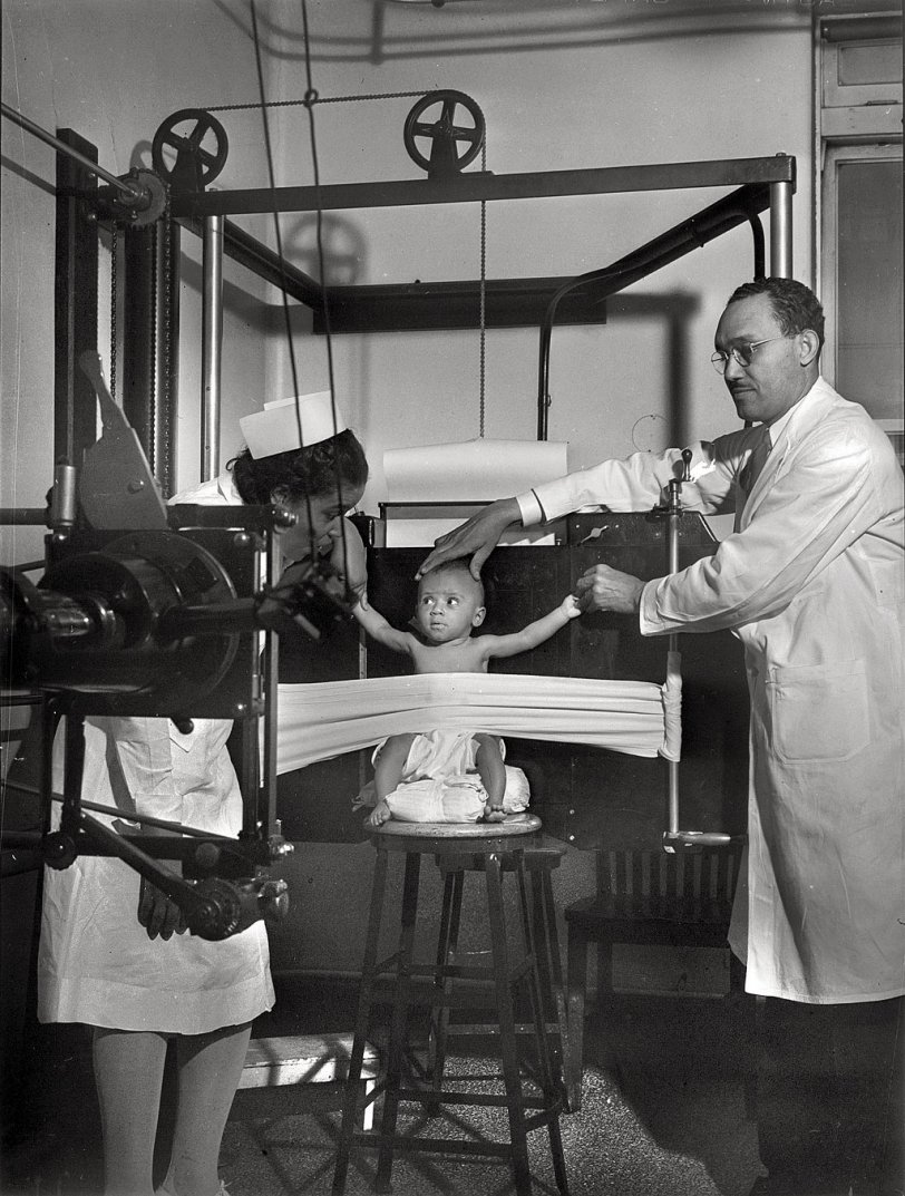 A baby is restrained for an X-ray at Provident Hospital in Chicago, Illinois. Photo by Jack Delano, March, 1942. View full size.
