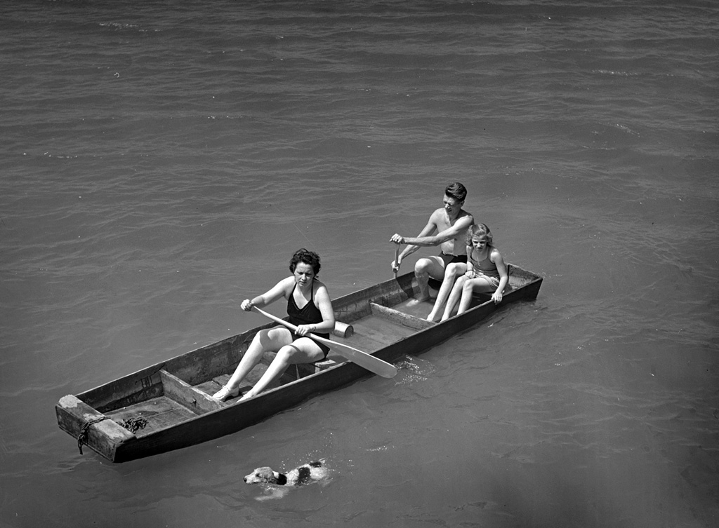 Sheffield, Alabama (Tennessee Valley Authority). Kenneth C. Hall, his wife and daughter rowing on the Tennessee River. Photograph by Arthur Rothstein for the Tennessee Valley Authority, June 1942. View full size.