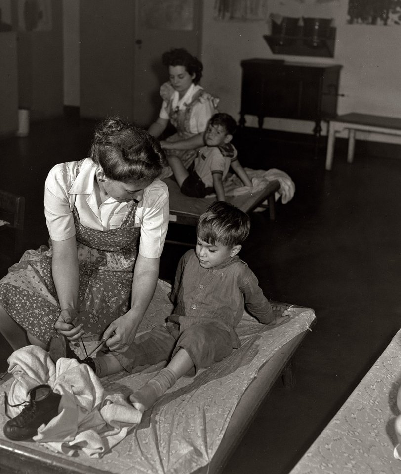 New York, June 1942. "Nursery school at the Queensbridge housing project. Dressing a child after a nap." View full size. 4x5 nitrate negative by Arthur Rothstein for the Office of War Information.