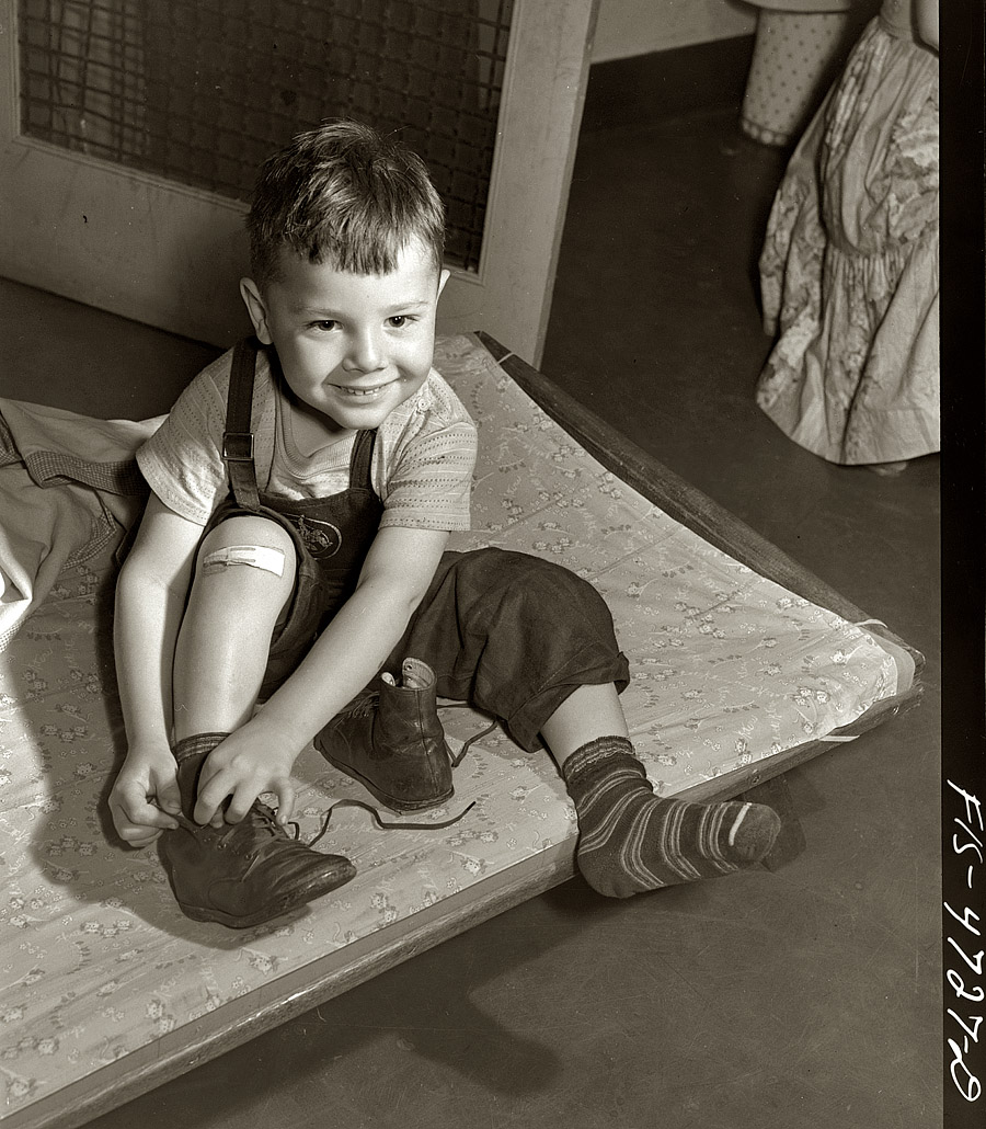 June 1942. "Queens, New York. Nursery school at the Queensbridge housing project. Child dressing after a nap." View full size. Medium format safety negative by Arthur Rothstein for the Office of War Information.