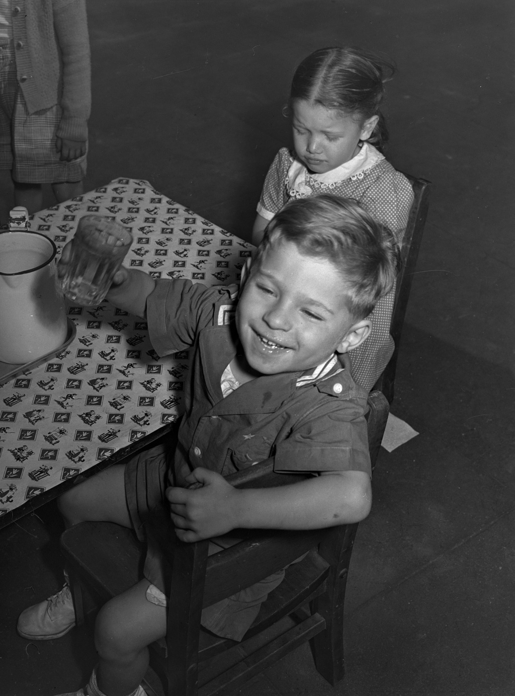 Children get milk or tomato juice after their nap at the nursery school at Queensbridge housing project in Queens, New York. Photograph by Arthur Rothstein, June 1942. View full size.