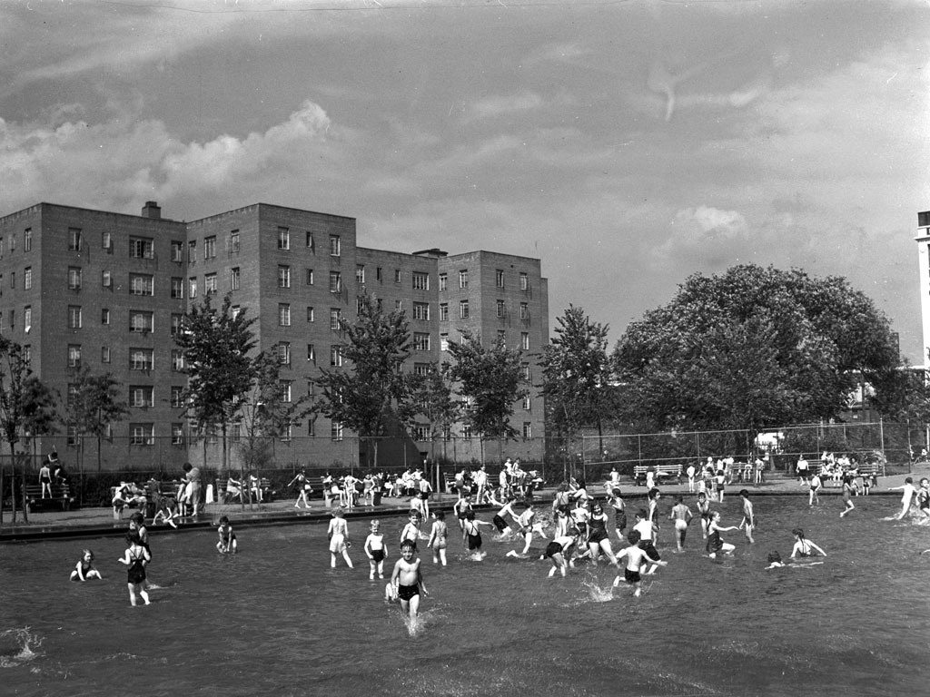 Children play in a wading pool at a play center at the Red Hook housing development, Brooklyn, New York. The charge to use the pool is nine cents for children, 25 cents for adults. Photograpy by Arthur Rothstein, June, 1942. View full size.