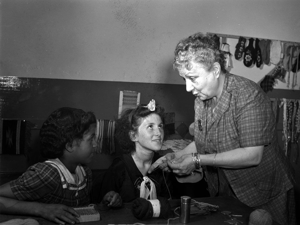 Students attend a class in knitting at the Red Hook housing project community center in Brooklyn, New York. Photograph by Arthur Rothstein, June 1942. View full size.