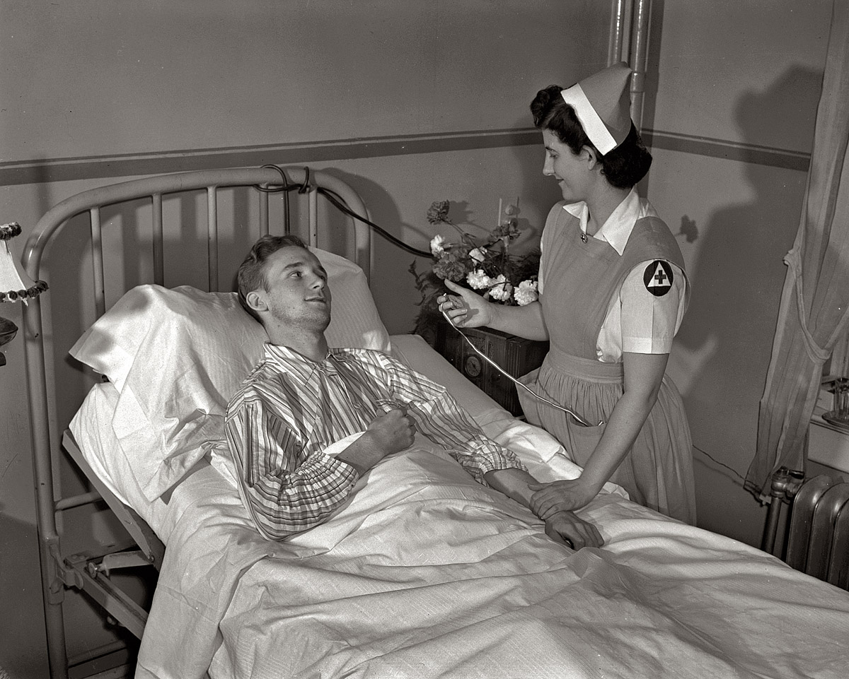 February 1942. Red Cross nurse's aide and wounded serviceman, location unknown. 5x7 safety negative, Office of War Information. View full size.