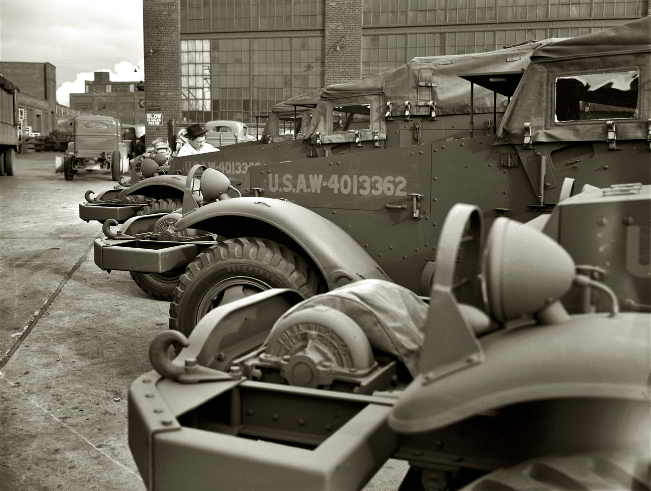 December 1941. White Motor Company, Cleveland. "Halftrac scout cars ready for the Army except for the addition of certain pieces of Army equipment. The cars as they stand in the yard of a Midwest manufacturer are ready for combat duty." View full size. 4x5 negative by Alfred Palmer for the Office of War Information.