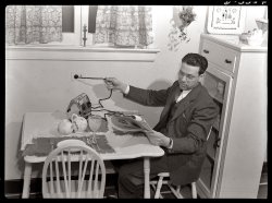February 1942: "Conservation of durable goods in wartime. Is it the news or is it indigestion? Whatever it is, this gentleman's mood is playing havoc with the electric cord. Don't try to disconnect a cord by tugging at it; dislodge it gently but firmly at the wall socket." View full size. Photograph by Ann Rosener for the Office of Emergency Management.