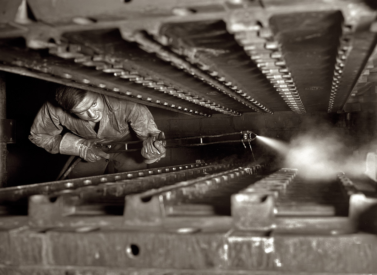 December 1941. "Treads for Army halftracks, made of rubber firmly bonded to steel members, are cured under heat and pressure in molds which are first sprayed with a lubricant. Goodrich tire plant, Akron, Ohio." View full size. 4x5 nitrate negative by Alfred Palmer for the Office of War Information.