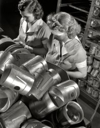 February 1942. Cincinnati, Ohio. "Aluminum casting. The heads of these heat-treated pistons must be spotted prior to Brinell hardness testing. Young women are employed for this job by a large Midwest aluminum foundry now converted to war production. Aluminum Industries Inc." 4x5 nitrate negative by Alfred Palmer for the Office of War Information. View full size. 