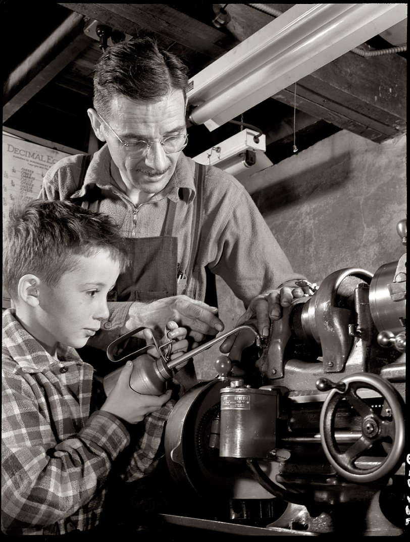 March 1942. "George Carell's seven-year-old son George Jr. likes to watch his father produce essential war equipment in his Passaic, New Jersey, home workshop. Mr. Carell belongs to a subcontract pool organized by the Howe Machinery Company." View full size. 5x7 negative by Howard Liberman.
