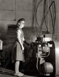 August 1942. Republic Drill and Tool Company, Chicago. "Women in industry. Tool production. Eyes averted from the white shower of sparks, this young employee of a drill and tool plant touches the button that welds drills to their shanks. She's one of nearly 1,000 women who have replaced men at the production machines of this Midwest factory." View full size. Medium format negative by Ann Rosener for the Office of War Information.