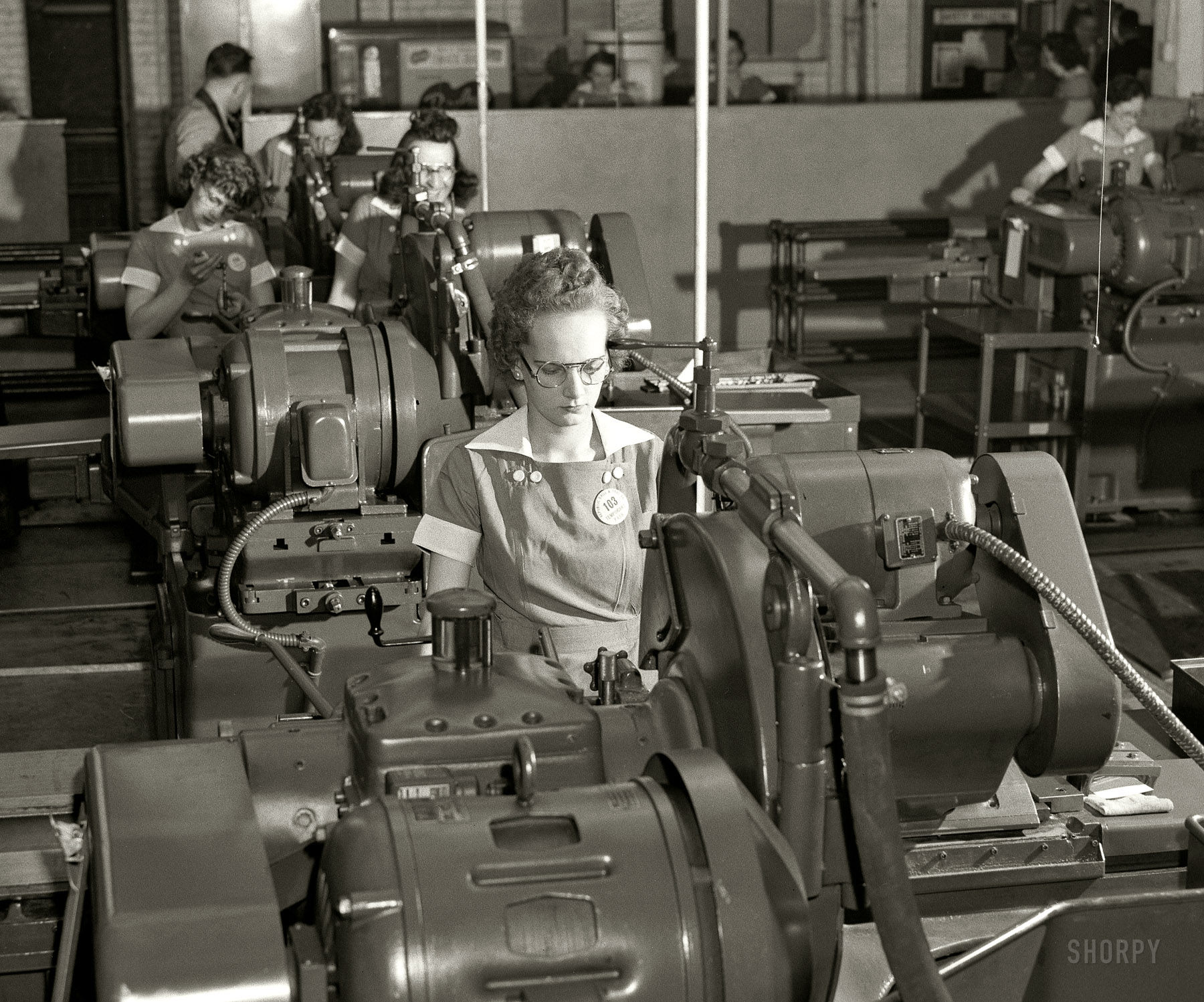 August 1942. "Women at work for victory. Republic Drill and Tool Company, Chicago. These young employees of a Midwest drill and tool plant are operating cylindrical grinders which taper drills to specified size. Used in the manufacture of guns, ships and tanks, these drills demand precise and accurate grinding." Medium format negative by Ann Rosener, Office of War Information. View full size.