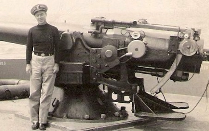 A picture of my father, LTJG C.R. Anderson by the stern gun of the SS Reverdy Johnson. The ship was a Liberty ship transport. The gun was a 4"/50 caliber of WW1 vintage. My father went to Armed Guard  Gunnery Officers School in Boston and Dam Neck, Virginia in late 1942. He then began his gunnery duty on merchant ships. His commands usually had about 25 non-rated sailors and one or two petty officers. Almost none of them were experienced USN personnel.  He told me that by the end of 1943 half of the officers with whom he had attended gunnery school were dead. Hard times! 
