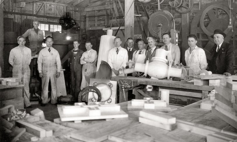 Vancouver, B.C., in the 1940s. Workers inside A-1 Steel Tom Sr.(R) owner. Those are patterns on the tables. The steel industry was taking shape and most of what my Grandpa Tom made here was chain to carry logs to the sawmills downriver. View full size.
