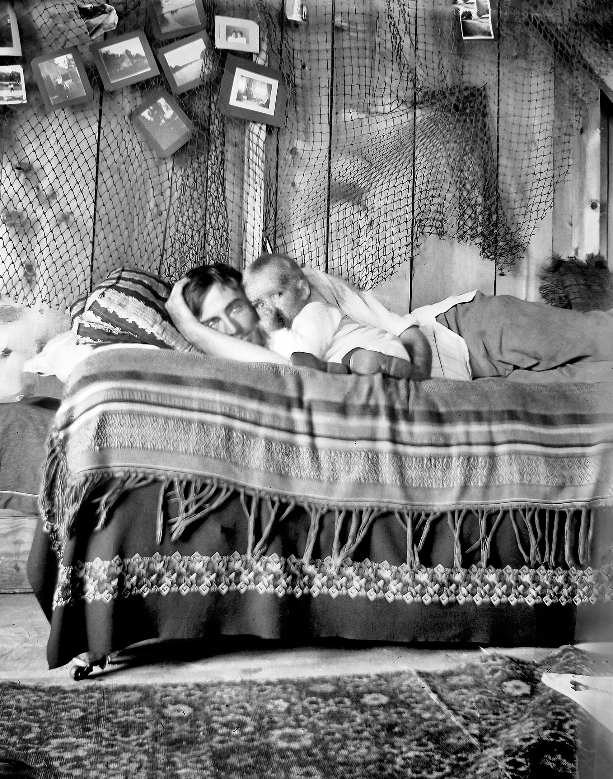 Trying to get the Li'l Cornhusker to sleep. Pawnee City, Nebraska, circa 1910 or earlier. Scanned from a 4x5 inch glass negative. View full size.