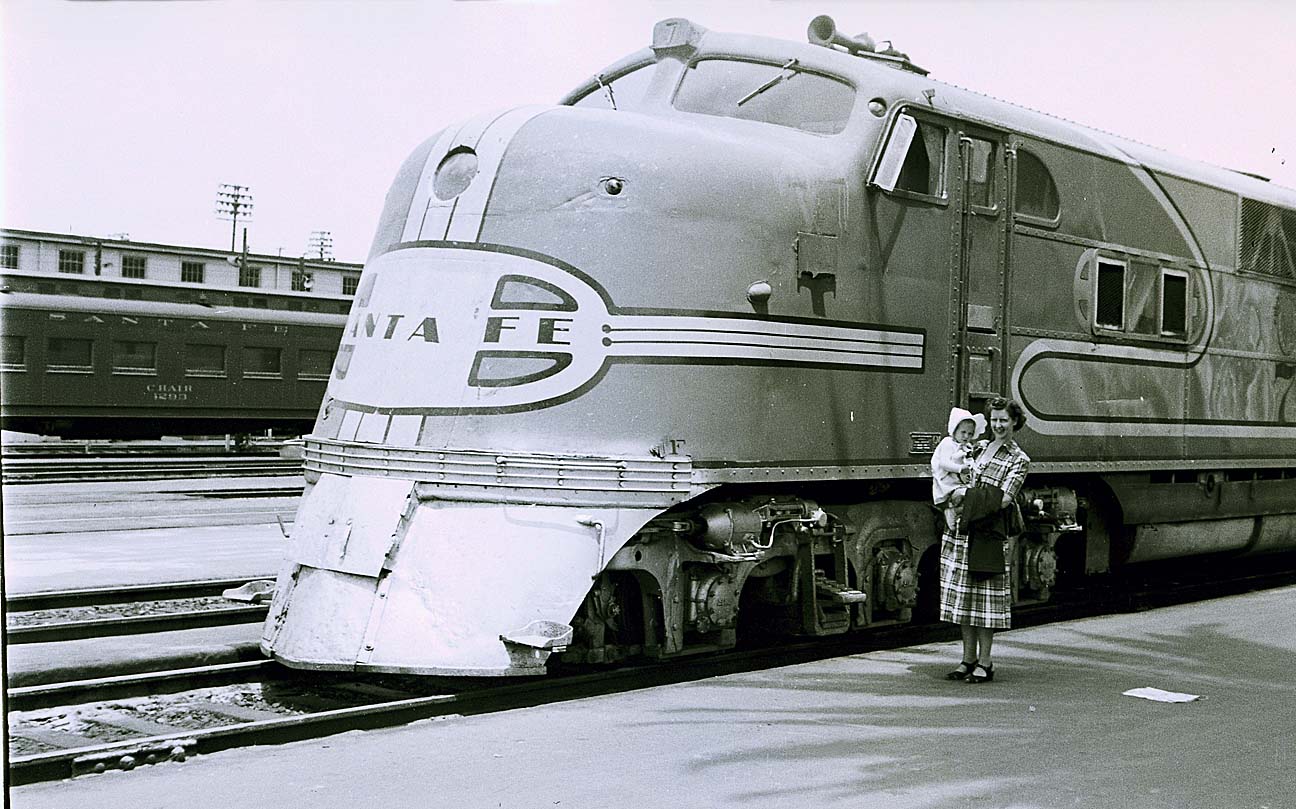 A Sante Fe E1A serves as a backdrop for my Mom and my sister in San Diego in July of 1949.  One of the first diesels that Sante Fe purchased, the locomotive was already 11 years old at the time of this picture.  

Photographer: Don Hall, Sr.

Don Hall