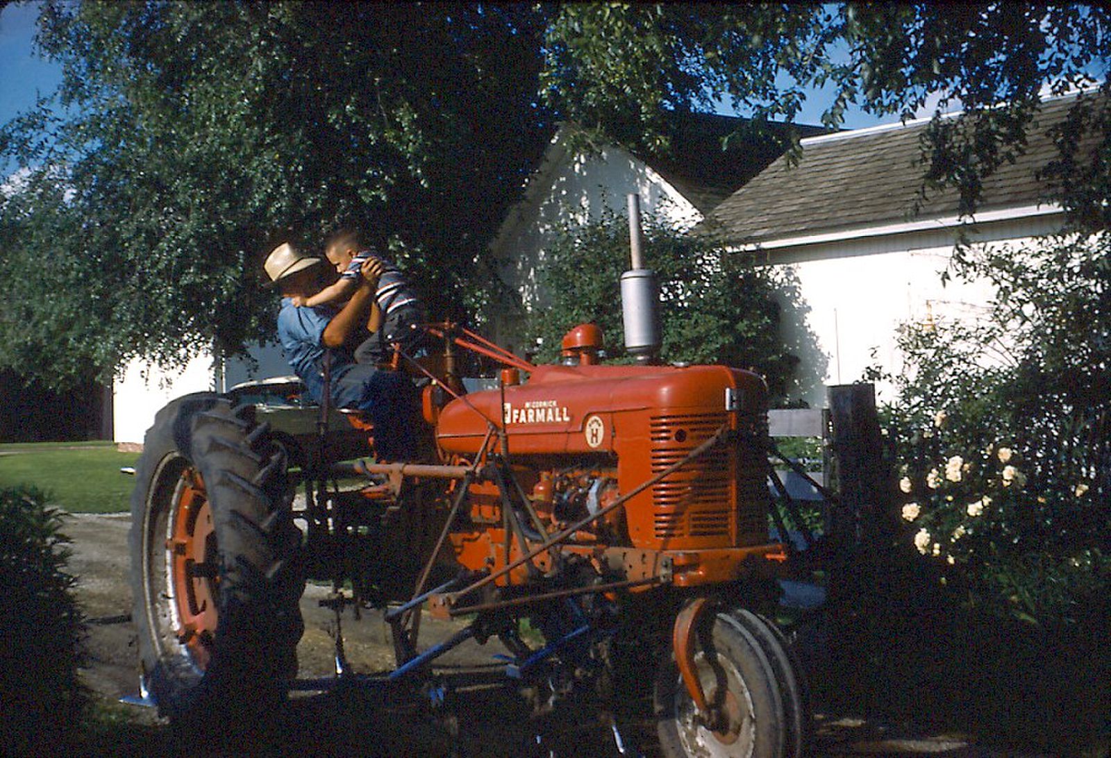 A ride on the tractor was fun, especially when I knew Grandpa would not let me fall. 1957 Kodachrome slide, taken near Blandinsville, Illinois. View full size.