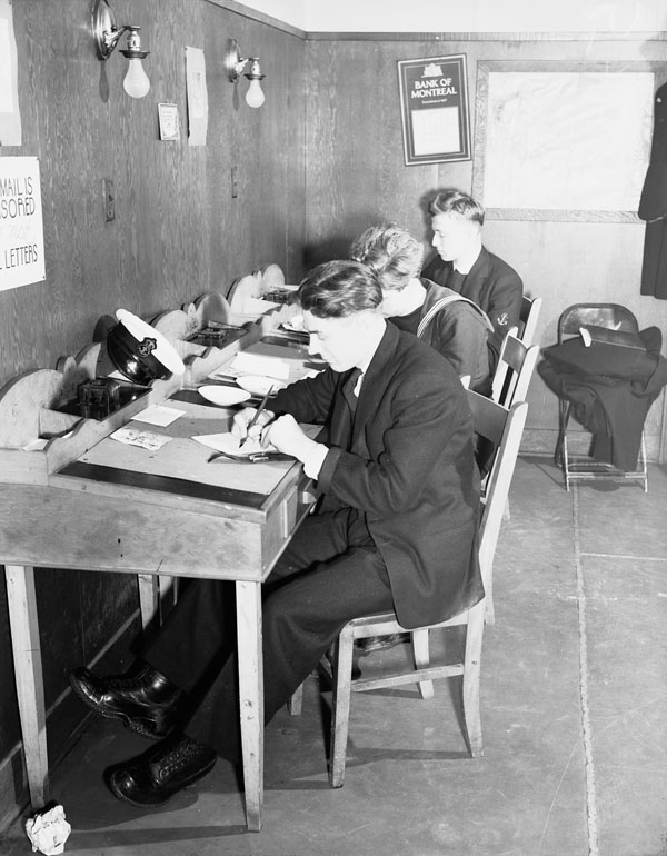 Canadian Navy personnel writing letters at the North End Services Canteen, Halifax, Nova Scotia, Canada, Feb. 6, 1943. (L-R): Motr Mechanic Albert Godier, Leading Telegrapher W.A. Furlonger, Electrical Artificer Irving Marcus. View full size.