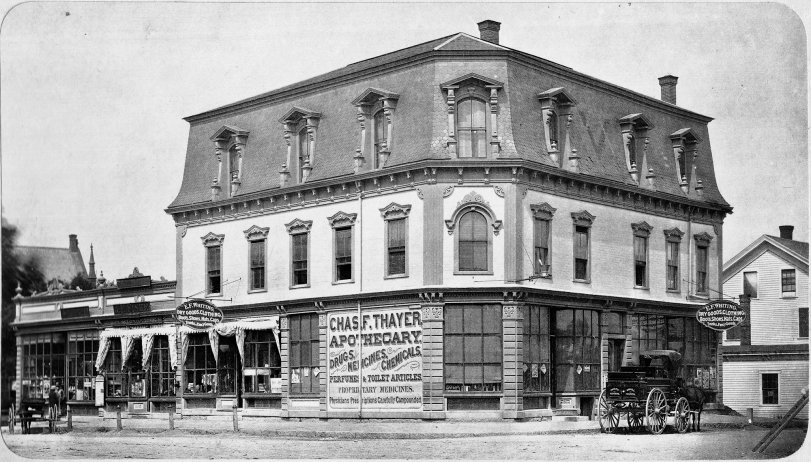 Downtown Holliston, Massachusetts, as it appeared in 1880. This building, the "Andrews Block", was constructed sometime in the 1860s, and served as the hub for this once-proud shoe-making town's commercial district. However, on December 28, 1898, tragedy struck when it and several other buildings were razed by fire.
Two years later it was replaced with its modern counterpart, the Cerel Building, which stands today, still housing one of the older buildings tenants. The "J.F. Fiske" shop (seen on the left) is still in businesss today as Fiske's General Store, and has been operating in the town nearly-continuously since 1863.
This photograph was taken from a limitedly printed viewbook compiled by the Lithotype Printing Company in New York, and distributed in the town around the year 1880. View full size.
