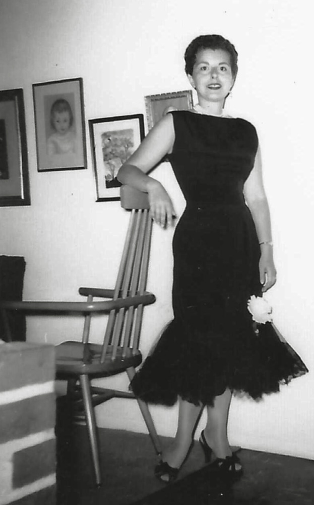 My mother was a fashionista before they had the word fashionista. She was also a dedicated sew and sew. As a consequence more than half of the photos in our family album are documentation of the clothes she designed and sewed. I think this may be the dress she made for my father’s mother’s funeral in 1959 because it is black, but I am not sure. Another theory is that she made it for the trip to Cincinnati that RCA sent my father on. That week-or-two trip included wives. In any event, it looks a heck of a lot like Barbie’s “Solo in the Spotlight” even down to the fake flower by her left knee.
In this photo (taken by my father) she is leaning on the top of the Paul McCobb "captain's chair" (previously seen here) in front of three drawings she did. The far left is a portrait of three-year-old me. The center picture is a tree. And behind her shoulder is a portrait of my father. The bricks in the foreground are part of the free standing fireplace that was a central feature of this mid-century modern Levittown home.
