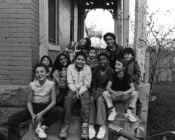 Many of the Arroyo grandchildren taken on the front steps of the family home on Curtis Street in Denver, Colorado, 1980 by James Arroyo.  These children are descendants from the original Hispanic settlers in Colorado and New Mexico. View full size.
Smiley!Look at all of those happy faces!  I am hispanic and this picture looks like it could come from my family album!  My cousins all were happy and a bit goofy like the kid in the back!  I am surprised there isn't a pair of bunny ears in the bunch!  And isn't it nice NOT to see a gameboy or cellphone texter in the picture?  You just know they were/are playing outside all day!
(ShorpyBlog, Member Gallery)