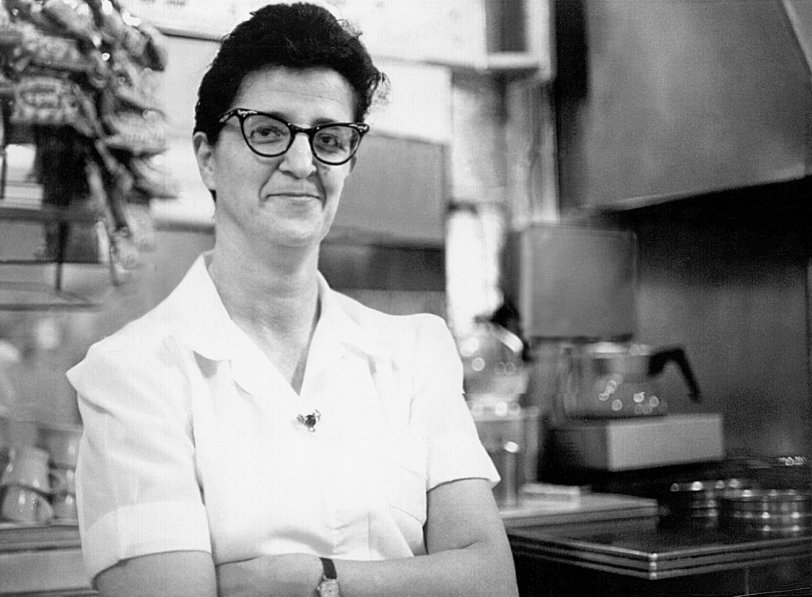This woman was a waitress at the Boston Candy Kitchen in Chatham, N.Y. (of recent Shorpy fame) in the 1950s when I was in high school there. To my shame I can't remember her name, but she saw every idiot thing teenaged customers could get up to and bore them all with great good humor: definitely a Good Egg.
I probably took this in 1964 with a Nikon F. The image was rescued from a snapshot-sized print found years later via lots of Photoshop work - no idea where the negative went. View full size.

